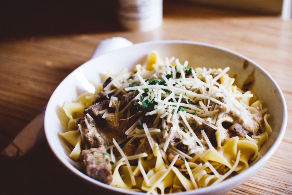 pexels-photo-154145 Delicious pasta with creamy mushroom sauce and Parmesan, garnished with herbs.